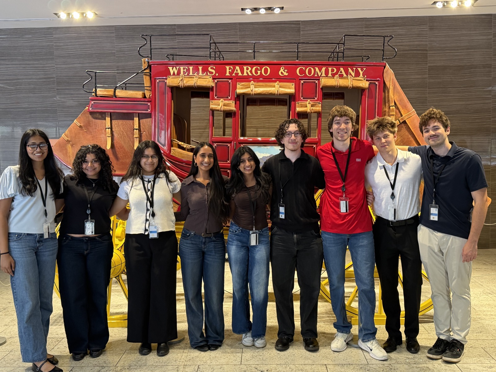 Wells Fargo interns standing in front of a stagecoach
